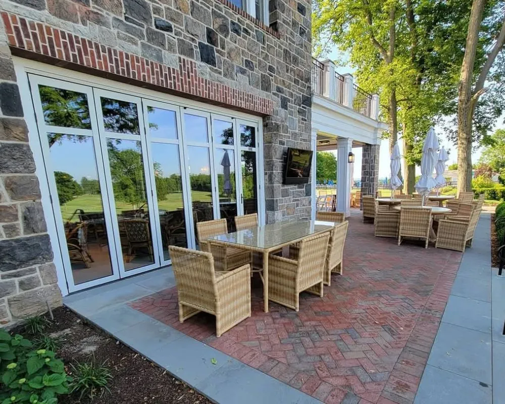 Outdoor patio with wicker furniture and brick pavers