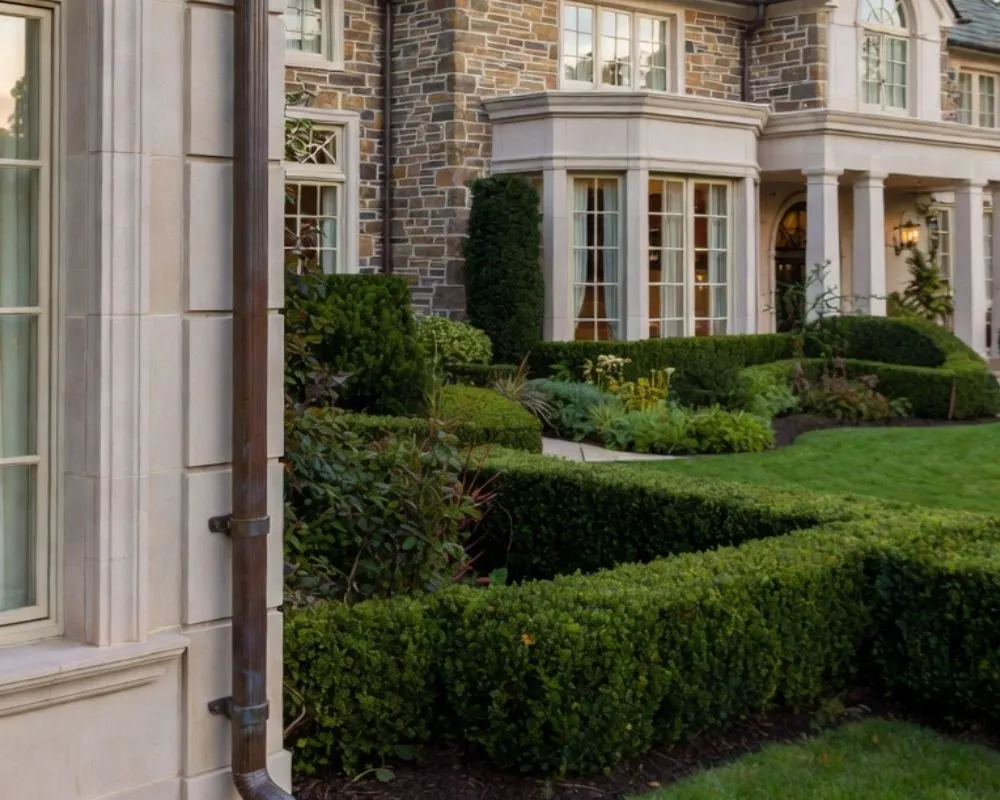 Luxury estate landscaping with manicured boxwood hedges in Pound Ridge NY